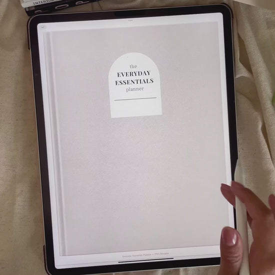 Planner cover with minimalist neutral tones displayed on iPad, stylus hovering over screen.